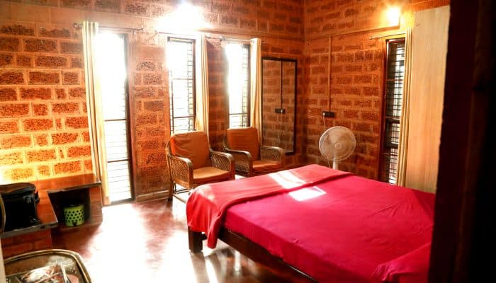 The master bedroom is naturally illuminated with tall windows.