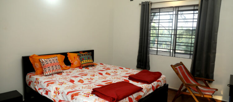 The spacious master bedroom on the first floor has high ceilings. It has an attached bathroom/toilet and a balcony.