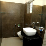 First bathroom on the ground floor has a wash basin, shower area and a flush toilet.
